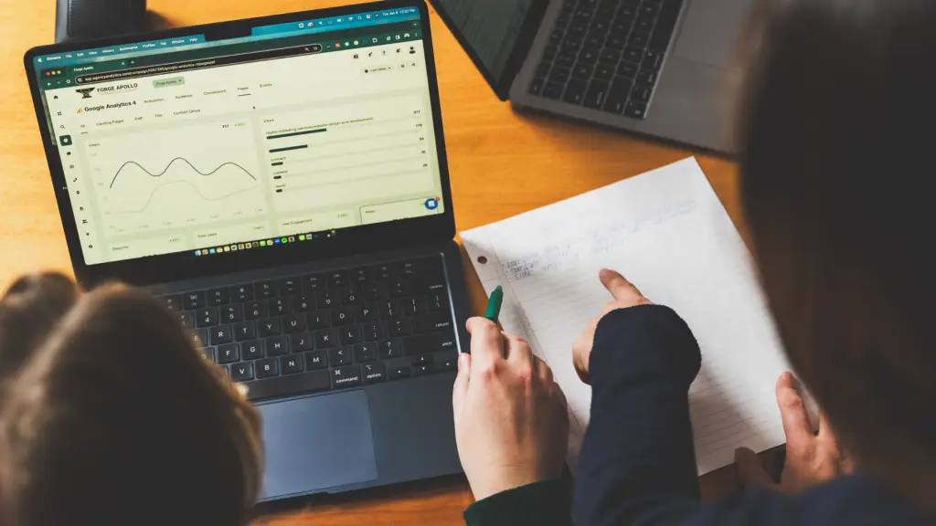 Two marketers reviewing reports to create SMART goals together