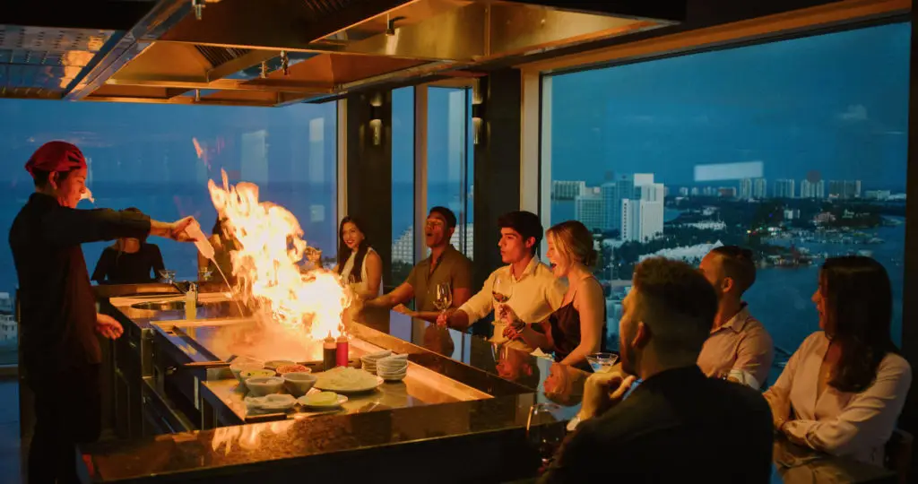 People smiling at a resort hibachi dinner
