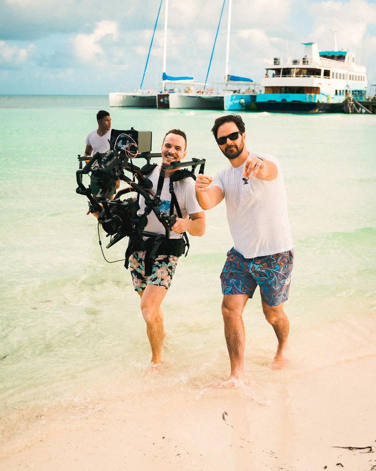 Video production crew filming on a resort beach