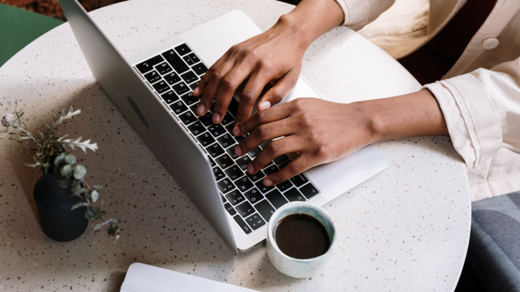 Closeup of hands typing on a computer
