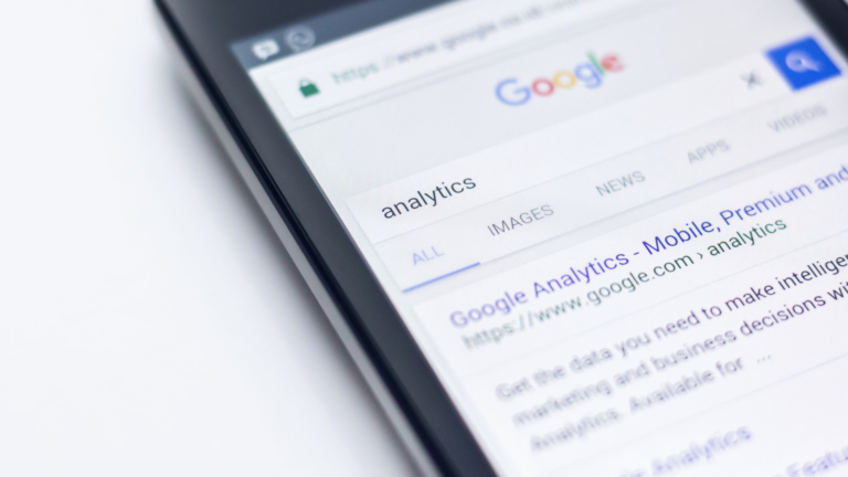 Closeup of phone screen with google search for "analytics"