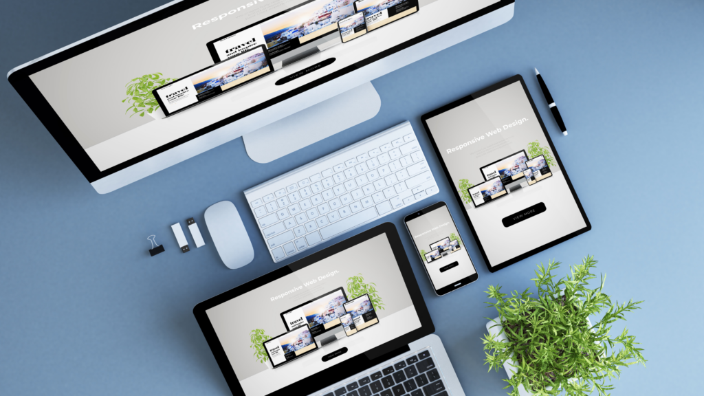 Desktop, laptop, tablet, and phone screen with responsive website designs displayed