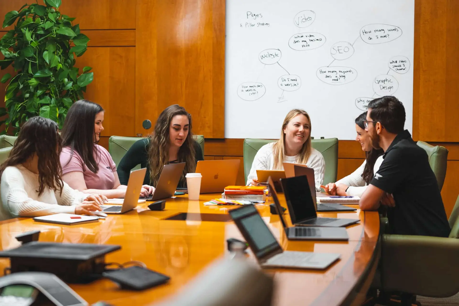 Marketing team strategizing around a conference room table