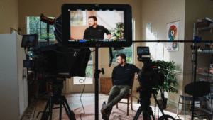 Camera pointing to a man on set for a healthcare video