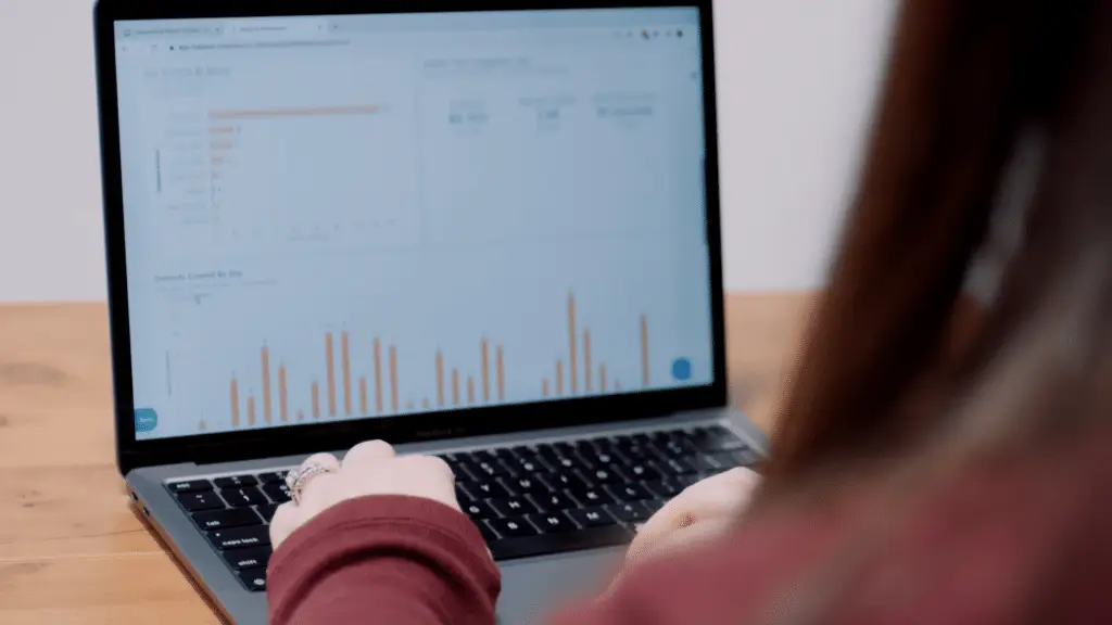 Marketing professional analyzing reports on a laptop