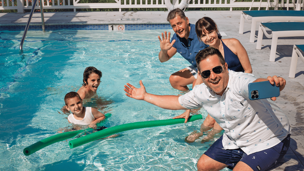 Family taking a selfie at a hotel pool