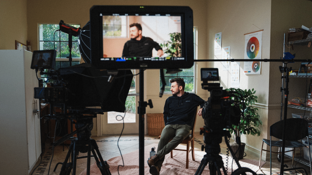 Cameras and preview screen on person at video production set