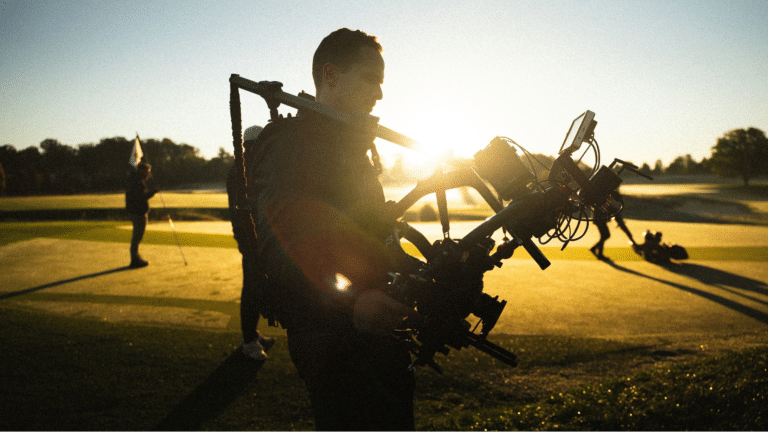 Crew member holding a camera on a video production set