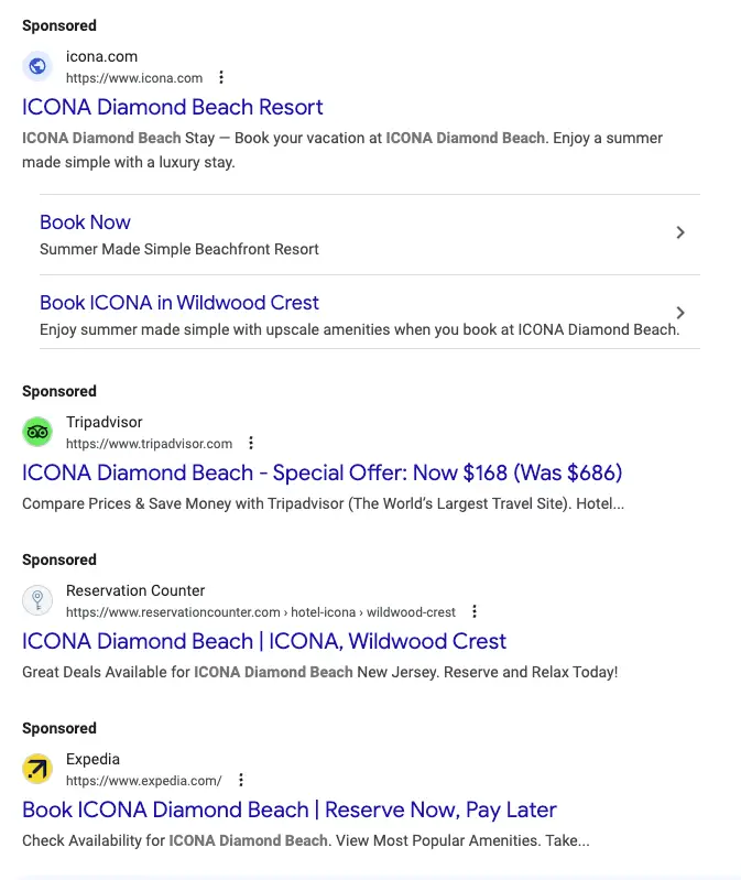 Several sponsored ppc hotel links from a search results page. The first is for ICONA Diamond Beach, the second is for TripAdvisor, the third is for Reservation Center, and the fourth is for Expedia.