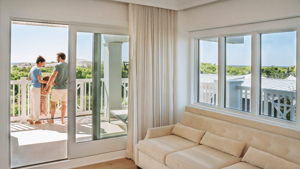 family standing on the balcony of their hotel room