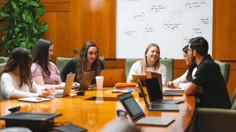 Digital marketing team strategizing at a conference room table