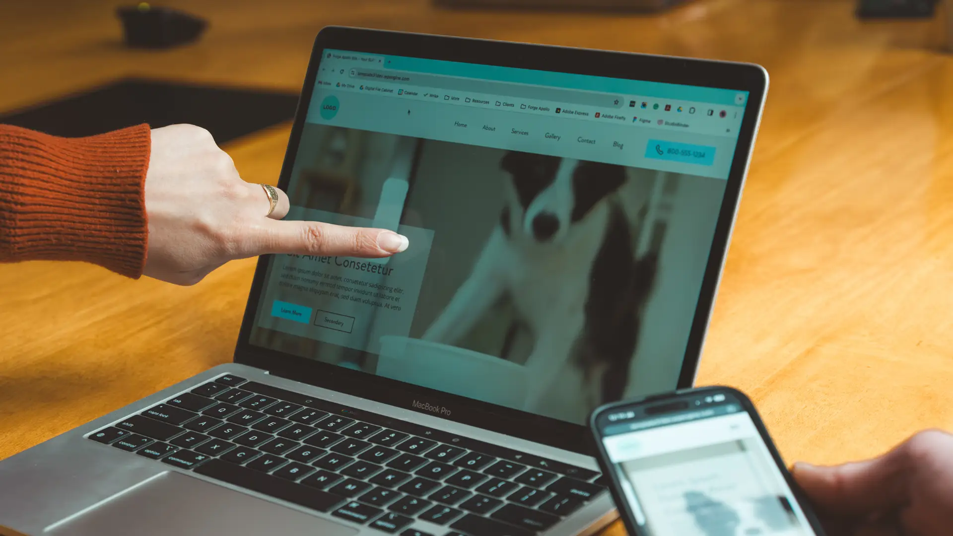 A Philadelphia website designer pointing to a video banner on a website on a laptop screen