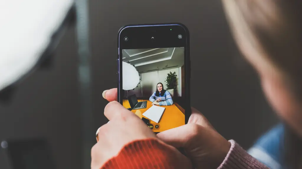 Social media marketer using a phone to record social media content